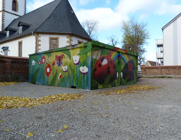 Lange bemalte Wand mit Wiese, Blumen und Tieren